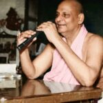 Swami Sivananda delivering inspiring spiritual discourse indoors