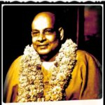 Swami Sivananda wearing sacred flower garland
