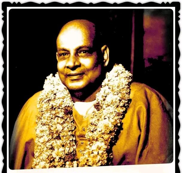 Swami Sivananda wearing sacred flower garland