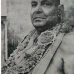 Swami Sivananda adorned with sacred flower garlands