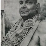 Swami Sivananda adorned with sacred flower garlands