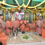Monks gathered for sacred worship inside beautifully decorated monastery prayer hall