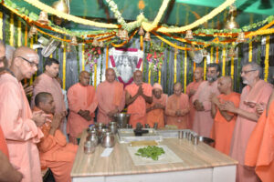 Monks gathered for sacred worship inside beautifully decorated monastery prayer hall