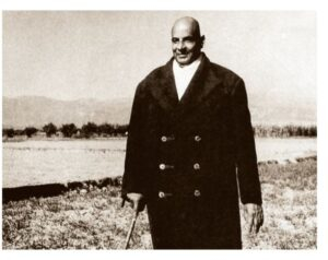 Swami Sivananda walking outdoors with peaceful expression
