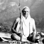 Swami Sivananda smiling during peaceful outdoor meditation