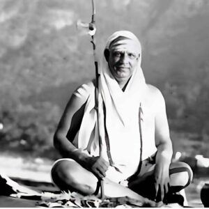 Swami Sivananda smiling during peaceful outdoor meditation
