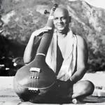 Swami Sivananda holding veena with joyful smile