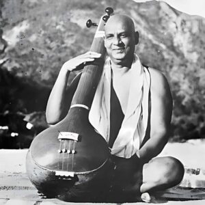 Swami Sivananda holding veena with joyful smile