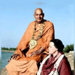 Swami Sivananda sitting outside with a devotee.