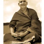 Swami Sivananda sitting in a serene pose.
