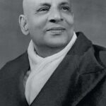 Black and white portrait of Swami Sivananda.