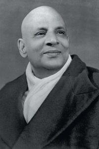 Black and white portrait of Swami Sivananda.