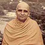 Hindu monk in saffron robes standing peacefully outdoors
