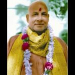 Manasic Puja spiritual guru wearing garland and sacred shawl peacefully