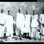 Swami Sivananda with disciples by riverside image