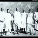 Swami Sivananda with disciples by riverside image