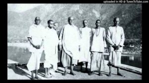 Swami Sivananda with disciples by riverside image