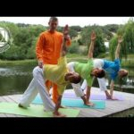 Gayatri Japa yoga instructor guiding students practicing outdoor poses together
