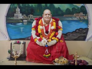 Bhakti guru adorned with flower garlands inspiring devoted seekers peacefully together