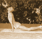 Person performing Bhujangasana in Surya Namaskara sequence