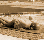 Person resting in Ashtanga Namaskara during Surya Namaskara