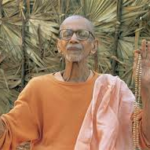 Hindu monk raising both hands in blessing outdoors