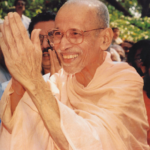 Smiling Hindu monk greeting devotees with folded hands outdoors