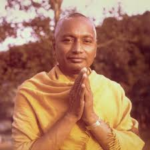 Spiritual teacher offering respectful Namaste with peaceful expression and devotion outdoors