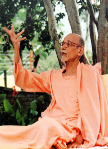 Swami Krishnananda Saraswati delivering profound spiritual wisdom beneath peaceful trees gracefully