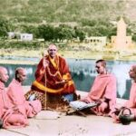 Swami Sivananda teaching disciples beside a sacred river