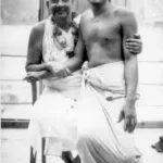 Swami Sivananda with devotee smiling together image