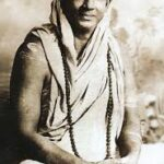 Swami Sivananda seated peacefully in traditional attire