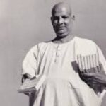 Swami Sivananda holding sacred spiritual books