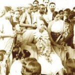 Spiritual guru delivering Message of Amrita among devoted followers gathered