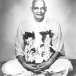 Anubandha Chathusthaya spiritual guru seated with sacred flower garlands peacefully