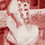 Swami Sivananda wearing sacred flower garland
