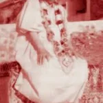 Swami Sivananda wearing sacred flower garland