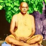 Swami Sivananda seated in meditation beneath a tree, radiating peace, wisdom, and spiritual serenity