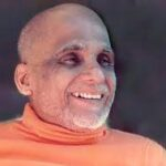 Swami Sivananda smiling with compassion and divine serenity