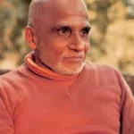 Elderly Hindu monk in saffron robe outdoors