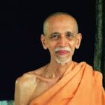Smiling Hindu monk in saffron robes portrait