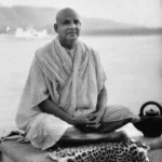 Swami Sivananda practicing Bhakti Yoga beside sacred river