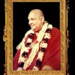 Framed portrait of Swami Sivananda with flower garland