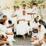 Swami Sivananda teaching devotees in peaceful gathering image