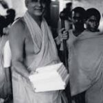 Swami Sivananda carrying books with devotees image