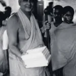 Swami Sivananda carrying books with devotees image