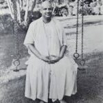 Spiritual master seated on garden swing image