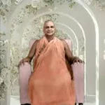 Swami Sivananda seated peacefully symbolizing God's existence