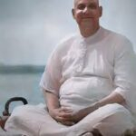Meditating spiritual teacher seated peacefully explaining background of thought and mindfulness
