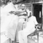 Swami Sivananda blessing a seated devotee